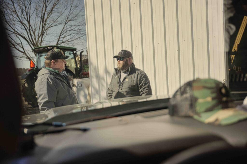 Men talking outside of truck