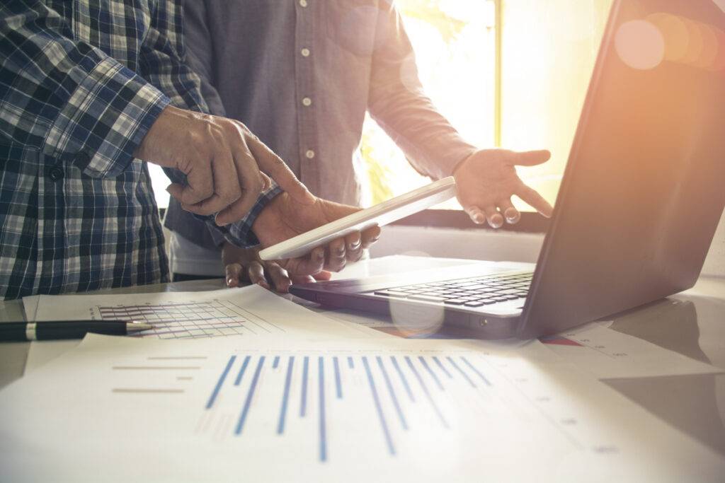 Farmer and ag retailer looking at laptop